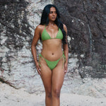 Scarlet, Tie Side Bikini Bottoms - Matcha on a model at the beach, showcasing cheeky coverage and high-cut fit.