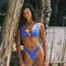 Girl on the beach wearing a blue bikini