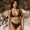Woman in a black clip front bikini and full coverage black bottoms