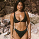 Woman in a black clip front bikini and full coverage black bottoms