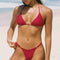 Girl wearing cherry red v front bikini bottoms on the beach