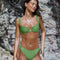 Isa Bikini Bottoms - Matcha worn by a model, featuring a flattering mid-high waist and high-cut leg design.