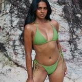 Scarlet, Tie Side Bikini Bottoms - Matcha worn by model on beach, showcasing cheeky coverage and adjustable ties.