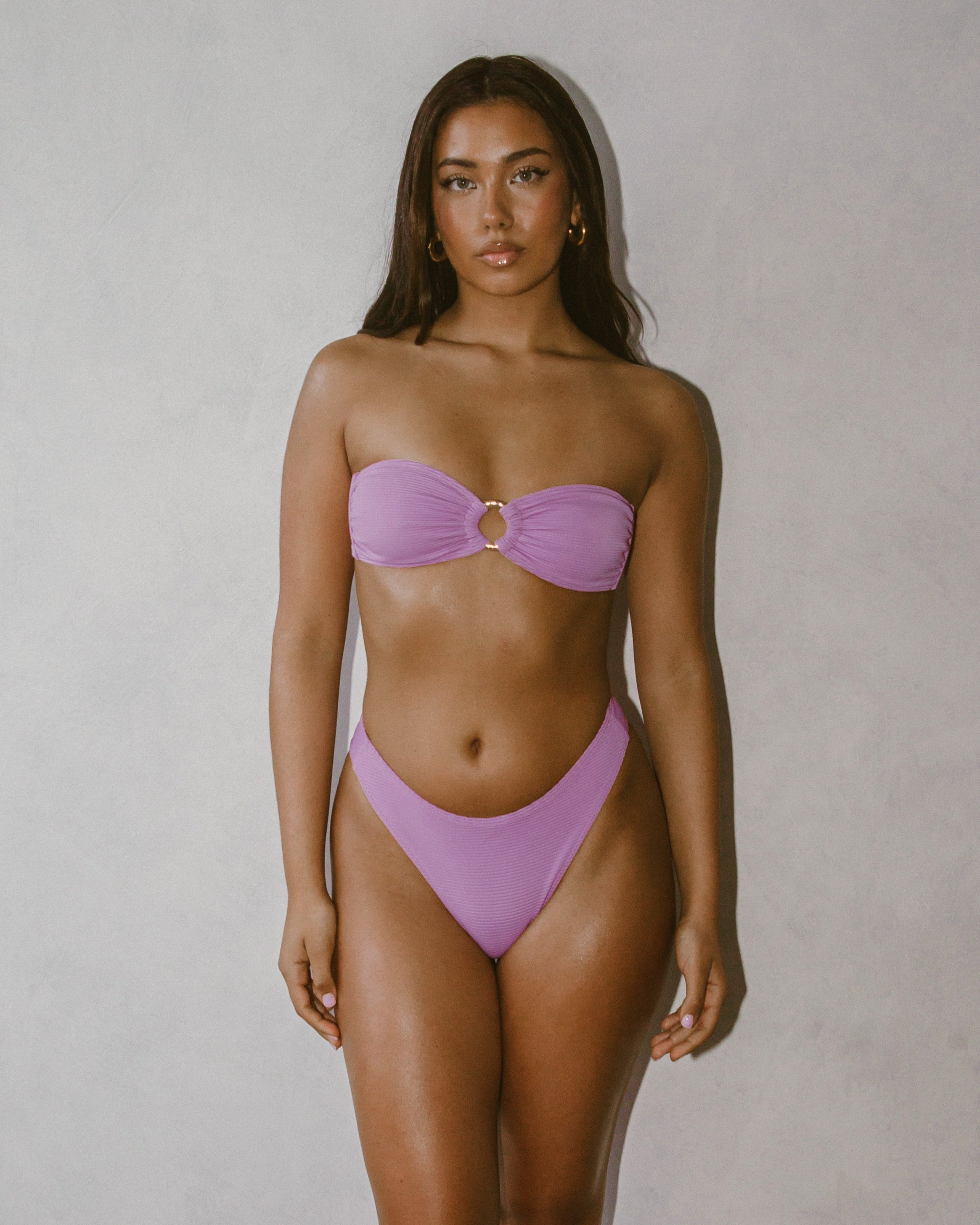 Isa Bikini Bottoms - Blush on model showcasing elegant style and high leg cut for flattering look.